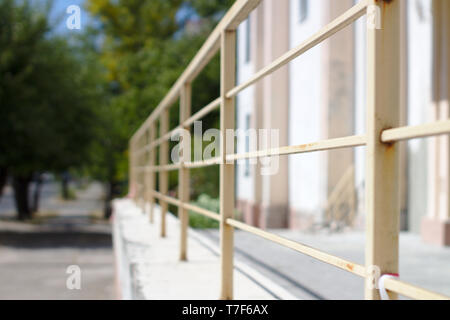 Abstract image of old rusty painted handrails receding into the distance. Stock Photo