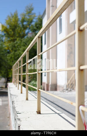 Abstract image of old rusty painted handrails receding into the distance. Stock Photo