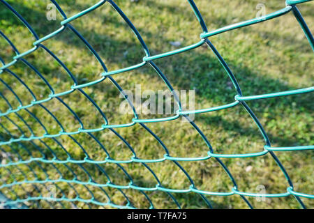 Green wire fence at the football pitch close up view Stock Photo
