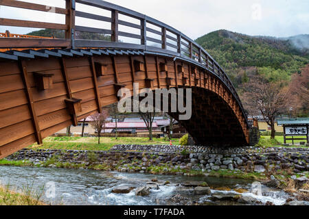This bridge crosses the Narai River, which runs parallel to the main street. Extending 30 meters, it is one of the longest arched wooden bridges in Ja Stock Photo