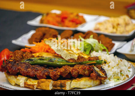 Turkish adana kebab with appetizers close up Stock Photo