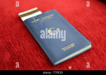 Turkish blue passport on red canvas background Stock Photo
