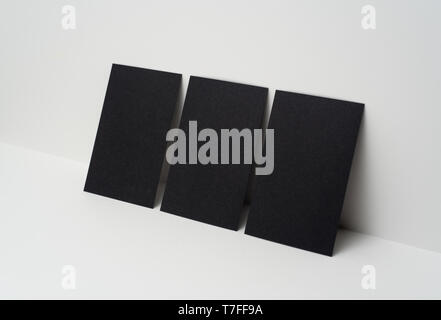 Design concept - perspective view of 3 vertical black business card on white 3D space background for mockup, it's real photo, not 3D render Stock Photo