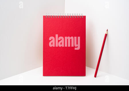 Design concept - perspective view of red spiral notebook, white page on white 3D space background for mockup, it's real photo, not 3D render Stock Photo