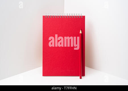 Design concept - perspective view of red spiral notebook, white page on white 3D space background for mockup, it's real photo, not 3D render Stock Photo