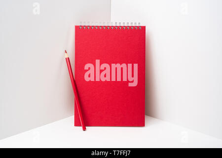 Design concept - perspective view of red spiral notebook, white page on white 3D space background for mockup, it's real photo, not 3D render Stock Photo