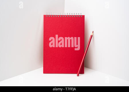 Design concept - perspective view of red spiral notebook, white page on white 3D space background for mockup, it's real photo, not 3D render Stock Photo