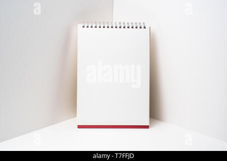 Design concept - perspective view of red spiral notebook, white page on white 3D space background for mockup, it's real photo, not 3D render Stock Photo