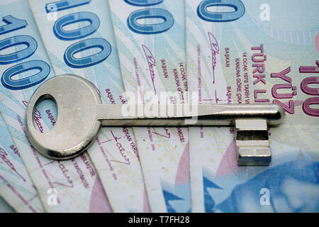 Turkish lira banknotes and assorted keys investment concept on isolated background Stock Photo