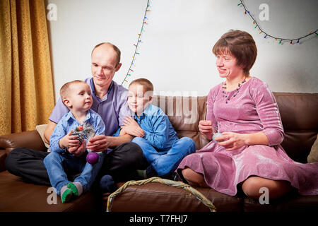 Happy family with two children cheerfully spend house time before Christmas Stock Photo