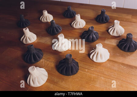 Black Georgian dumplings Khinkali with meat on white plate. Stock Photo