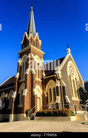 Facade of St Paul Presbyterian Church, built in 1881-82 in Gothic Revival design with a tall steeple, arched lancet windows and an impressive rose win Stock Photo