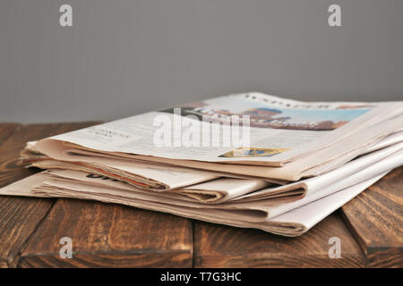 Pile of newspapers on wooden table Stock Photo