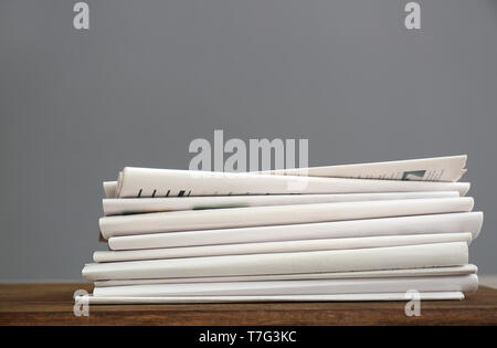 Pile of newspapers on wooden table Stock Photo