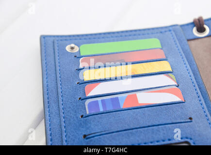 Wallet with credit cards on a white wooden table. Stock Photo