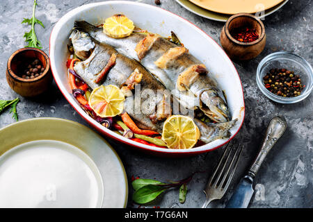 Trout with bacon baked in the oven. Fish with vegetables Stock Photo