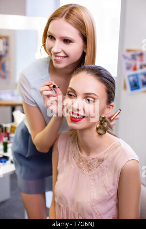 Joyful positive young woman enjoying her eyelashes Stock Photo