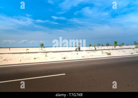 View of the road the with sandhill in Phan Thiet, southern Vietnam. Phan Thiet is a coastal port city in Southeast Vietnam. Stock Photo