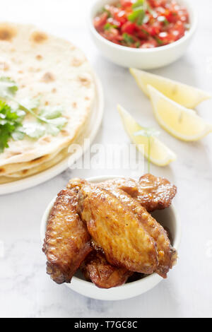 Homemade delicious food of tortillas, salsa and fried wings. Selective focus. Stock Photo