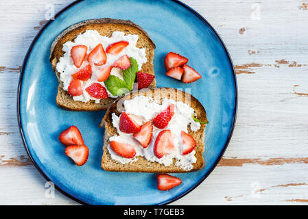 Snack from Wholemeal Bread Toasts, Ricotta cheese and Strawberri Stock Photo