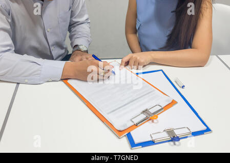 Asian business people hand sign the business contract Stock Photo