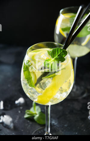 Two shot of mojito cocktail in glass with garnish on black table. Close up. Stock Photo