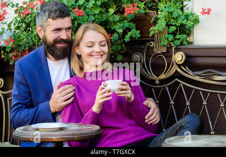 Married lovely couple relaxing together. Travel and vacation. Explore cafe and public places. Couple cuddling cafe terrace. Couple in love sit cafe terrace enjoy coffee. Pleasant family weekend. Stock Photo