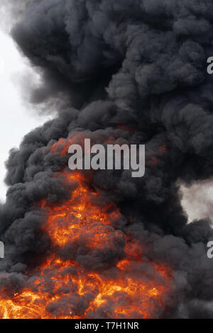 Black motion clouds of strong fire smoke covered sky. Defocus and ...