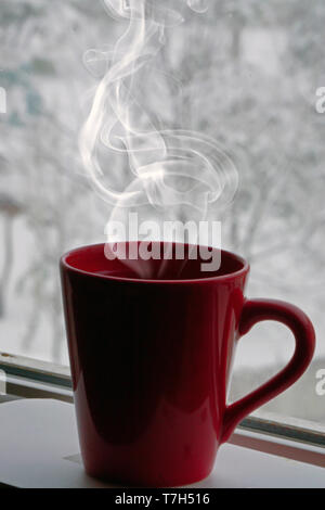 Red mug with hot coffee or tea drink on snow in winter Stock Photo by  molenira