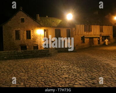 Historic town center of Conques at night, along the Via Podiensis, also know as Le Puy Route, in southern France. Next to Abbey-Church of Saint-Foy. Stock Photo