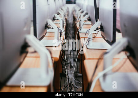 Group of desktop computers on the table in computer lab room - Close-up shot Stock Photo
