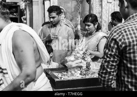 Singapore, March 12th, 2019, Devotees at Sri Veeramakaliamman Temple at nighttime in Singapore. The temple is dedicated to Veeramakaliamman or the god Stock Photo