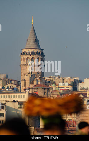 A Turkish man carries Simit on a tray on his head on the Galata Tower, Istanbul, Turkey Stock Photo
