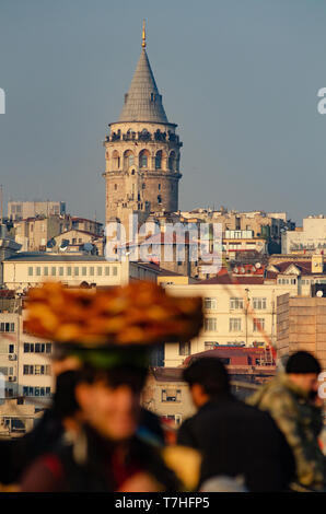 A Turkish man carries Simit on a tray on his head on the Galata Tower, Istanbul, Turkey Stock Photo