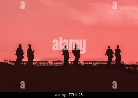 Sculptures of saints in Vatican. Silhouette on the coral color sky background. Details Stock Photo