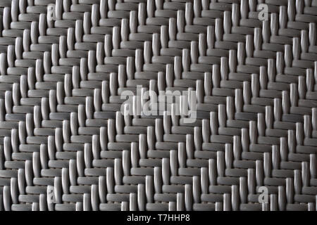 close up of gray artificial rattan plastic lined knitted ready for outdoor table or chair production in the furniture factory. texture and background  Stock Photo