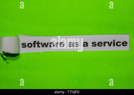 Software as a Service, Inspiration and business concept on green torn paper Stock Photo