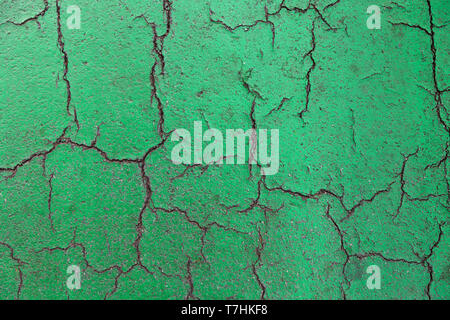 close up broken surface of deteriorating green tennis court floor. background and sports concept. Stock Photo