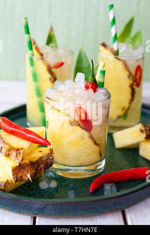 Colorful spicy cocktail with fresh pineapple and chili peppers Stock Photo