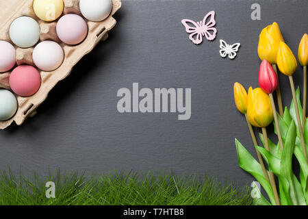 Happy easter background with colorful easter eggs and tulips Stock Photo