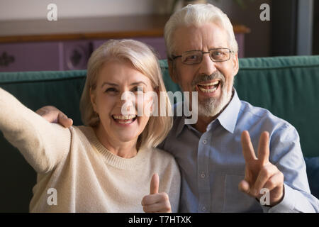 Head shot portrait happy mature man and woman taking selfie Stock Photo