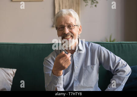 Head shot portrait of smiling mature man looking at camera Stock Photo