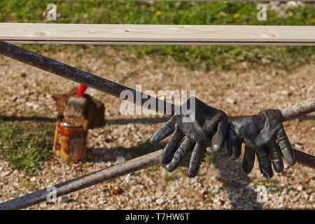 Used work gloves and paintbrush.Construction concept. Stock Photo