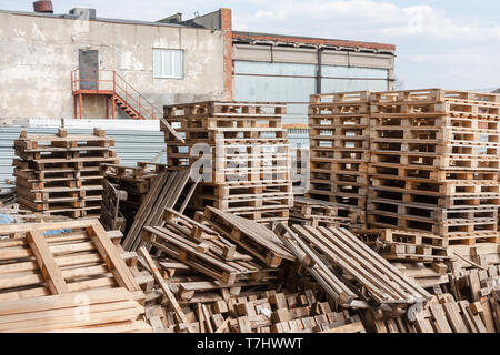 Messy warehouse of old wooden shipping pallet Stock Photo