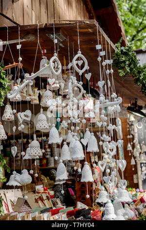 Ceramic white bells sold in gift shop at traditional spring fair Stock Photo