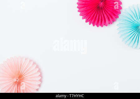 Stylish flat lay party background of tissue paper decorations of pink and blue colors on white table, top view. Stock Photo