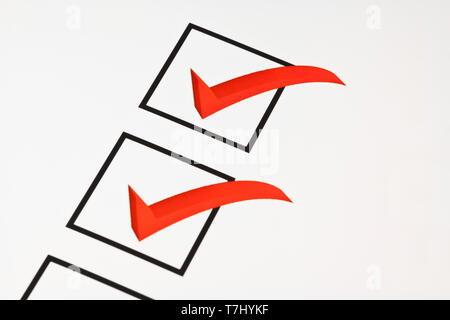 Red ticks on a questionnaire symbolic of customer satisfaction. Stock Photo