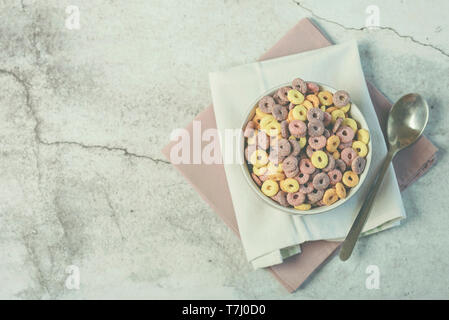 bowl of colorful cereals and spoon on Grunge background Stock Photo