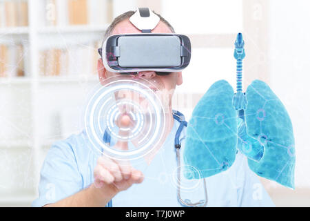 Medical doctor using virtual reality headset at his work with lungs Stock Photo
