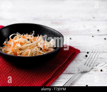 Sauerkraut at white rustic wooden background. Typical fermented food in some countries such as Russia, Poland or German.  Stock Photo